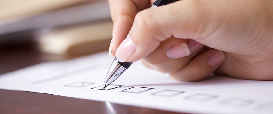 A patient marks the procedures she needs off her preventive care checklist.