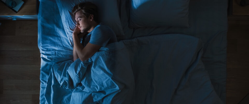 Man with low back pain sleeping