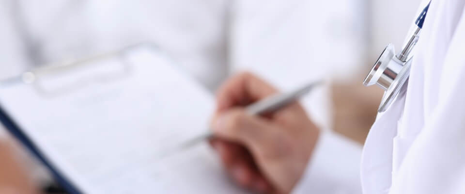 Doctor taking notes at urgent care clinic