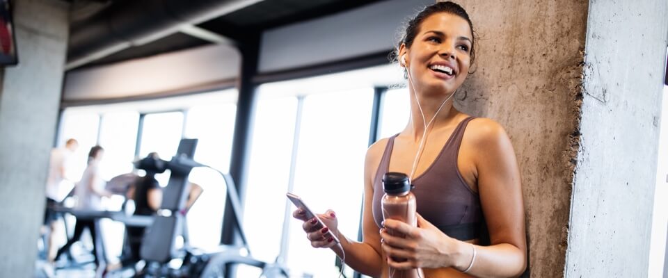 Woman on phone in gym
