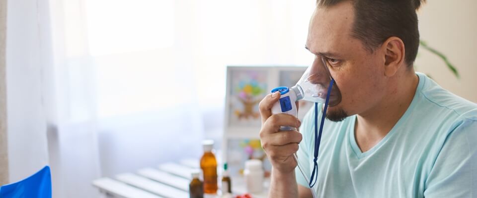 Man in hospital bed with nebulizer