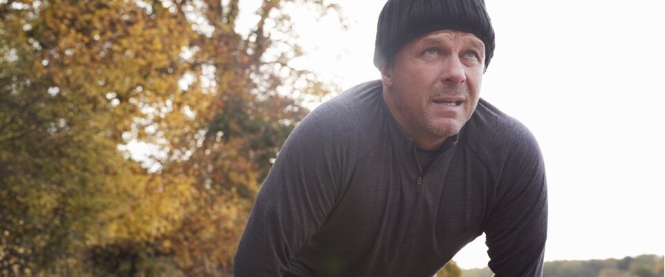 Man bending over, breathing heavily