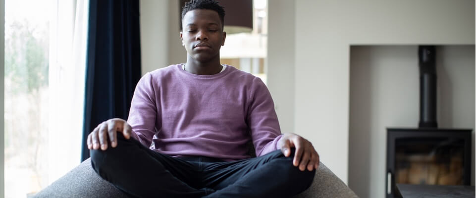 Man meditating to quiet distressing thoughts