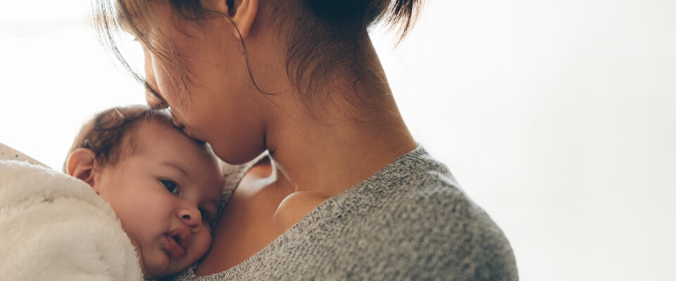 Woman kissing infant