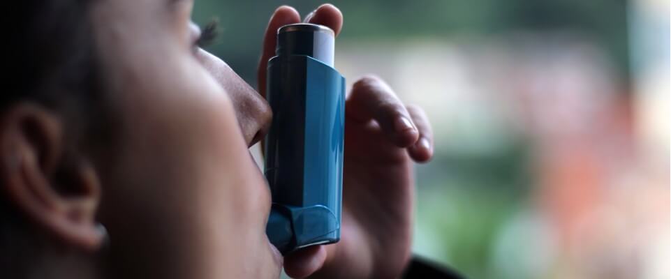 Woman using inhaler