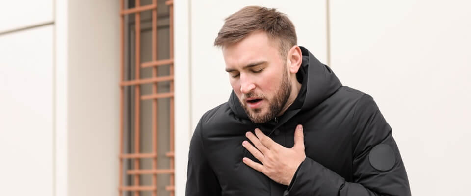 Man clutching his chest with his mouth open