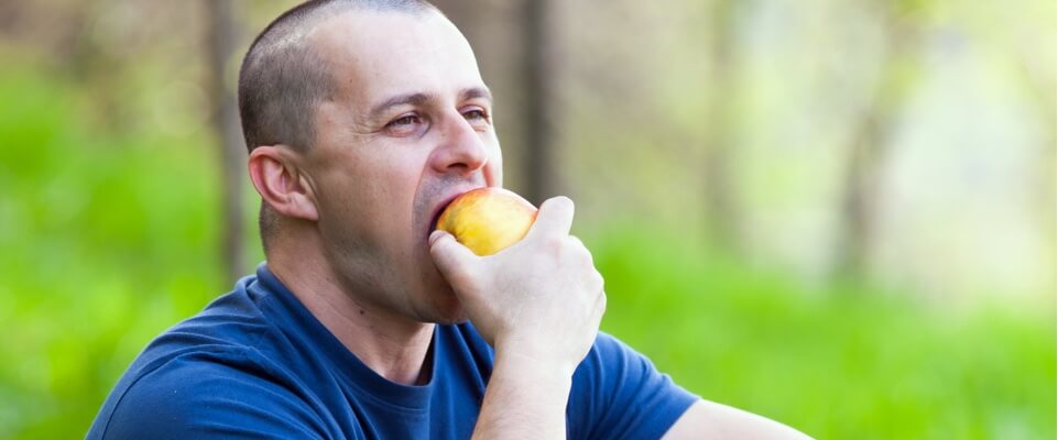 man eating fruit