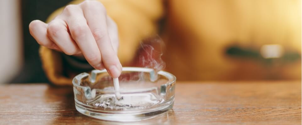 person putting cigarette out